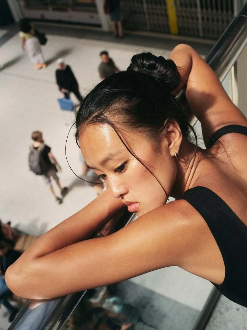 Resting on a handrail above a station concourse